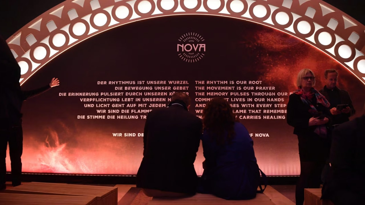 Visitors sit at the opening of the "Nova Music Festival Exhibition" in the former Tempelhof Airport in Berlin, Oct. 5, 2025