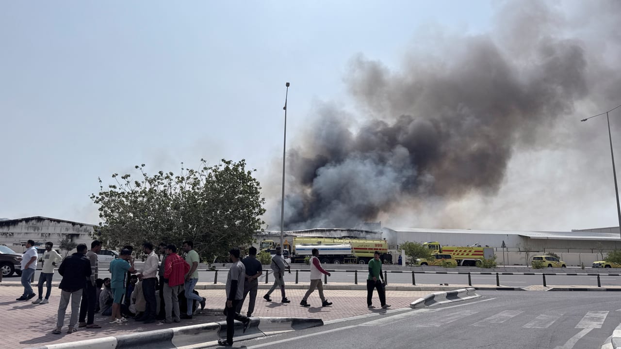 People gather as smoke rises at the Industrial Area after reported Iranian missile attacks, following United States and Israel strikes on Iran, in Doha, Qatar, March 1, 2026