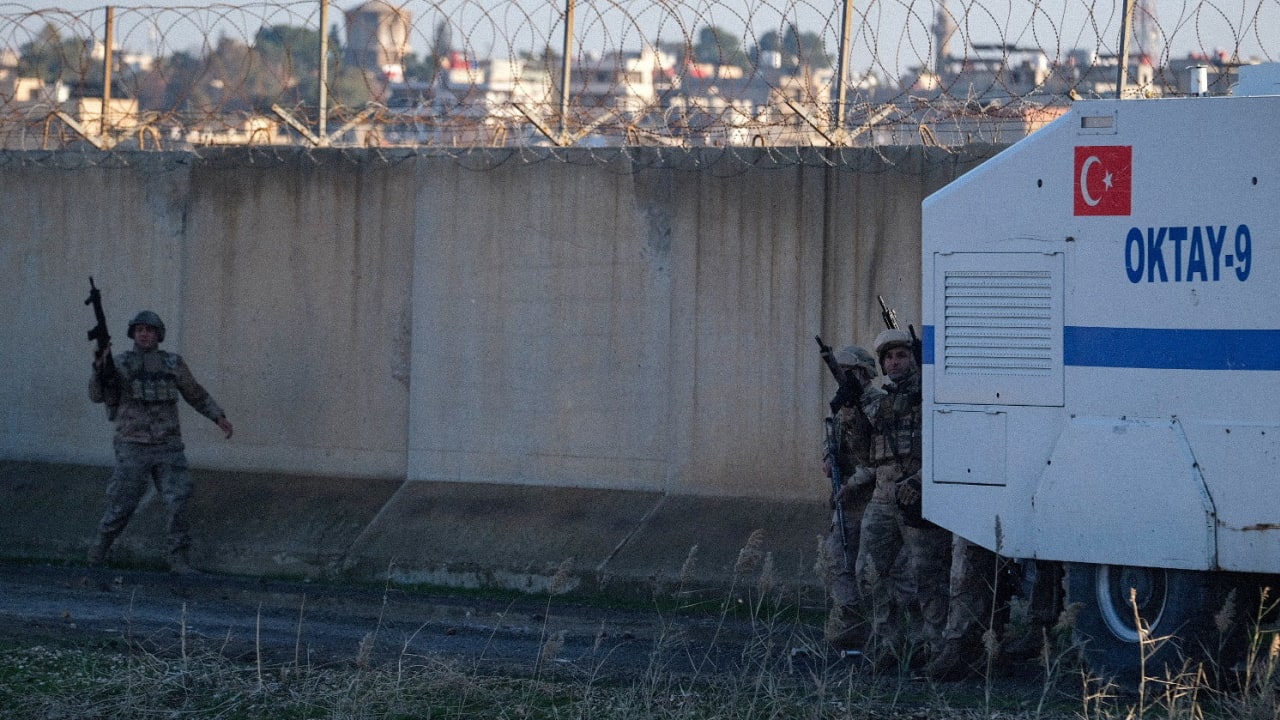 Turkish soldier guard the border while Pro-Kurdish protesters gather on top of a hill as they try to march to the border zone with the Kurdish-controlled northeastern Syrian city of Qamishli. January 20, 2026.