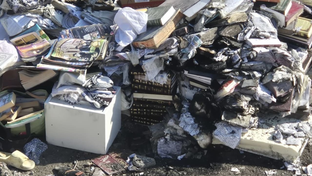 A pile of sacred books inside the ruins of a home hit by a missile launched from Iran.