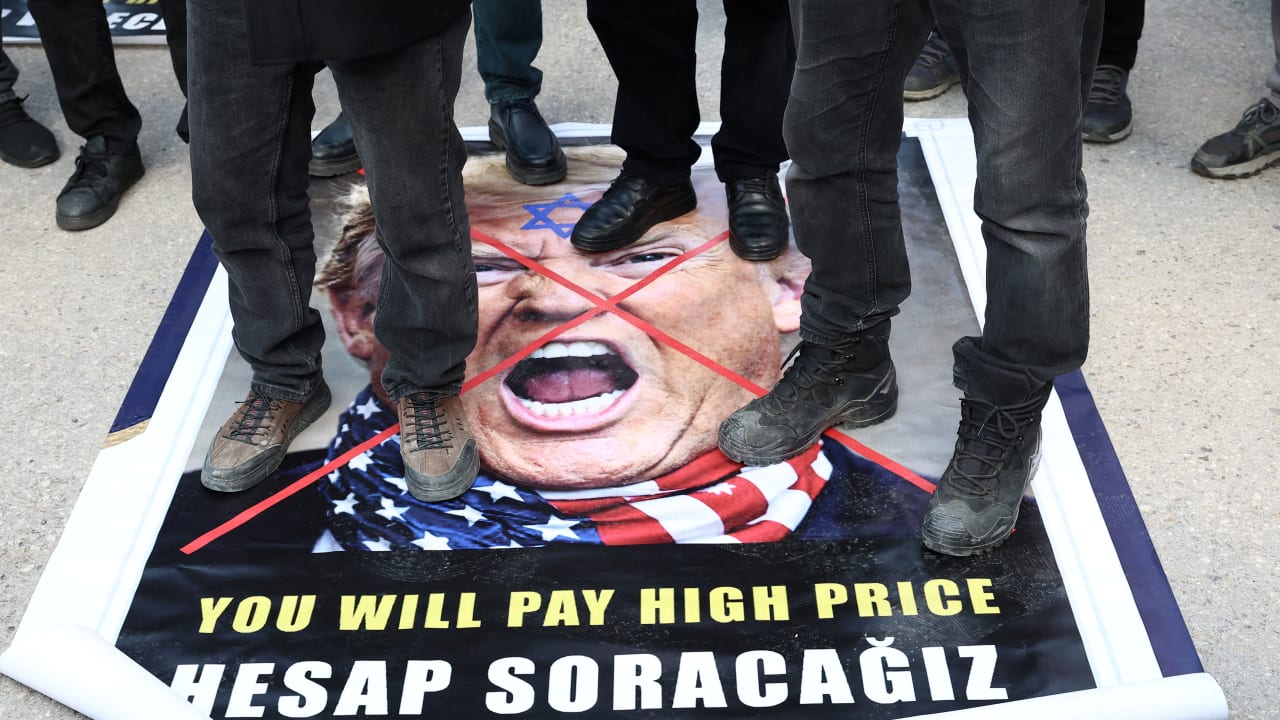Demonstrators protesting against the attacks on Iran step on a poster of US President Donald Trump, in Turkey, last week. While it’s true that America cannot fight every war, it is certainly obligated to fight against those who have threatened to finish it off, the writer says. 