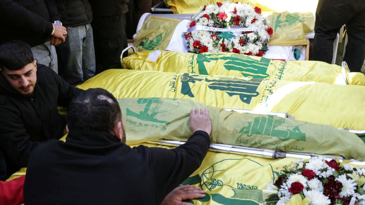 Mourners gather around the Hezbollah-draped coffins and bodies of people killed earlier this week in Israeli airstrikes on Baalbek, during their funeral in the Lebanese eastern city on March 5, 2026. 