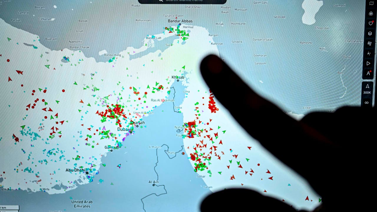 A person points at a page on the Marinetraffic website that shows commercial boats traffic on the edge of the Strait of Hormuz near the Iranian coast, in Paris on March 4, 2026.