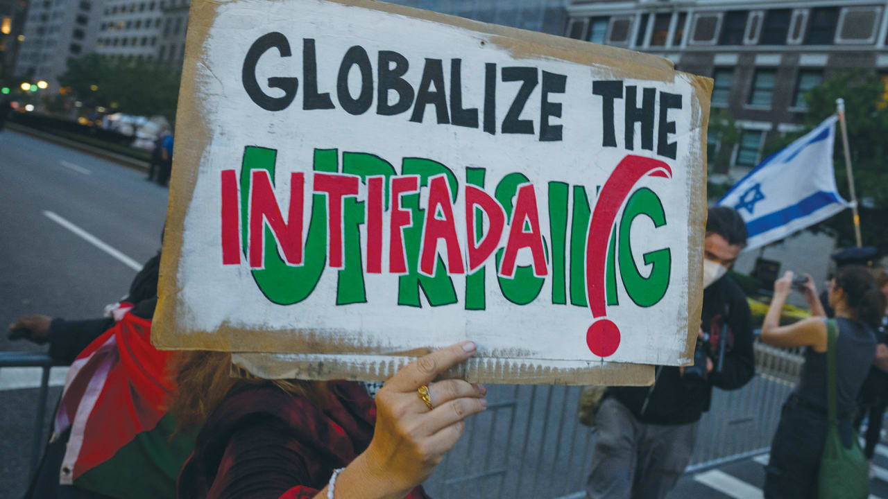 A PRO-PALESTINIAN protester holds a ‘Globalize the intifada’ sign near during an Anti-Israel protest in New York City, last year. The phrase is a call to expand the violence that killed thousands of Israelis in two terrorist uprisings and extend it worldwide against global Jewry, the writer says.