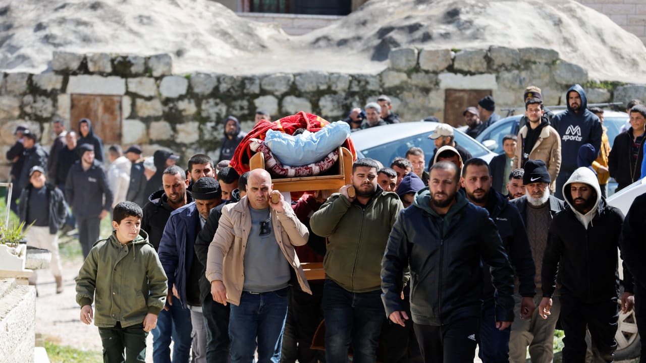 Mourners carry the body of a Palestinian reportedly killed by an Israeli settler, near Hebron in the West Bank, March 8, 2026