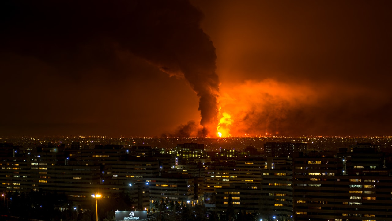 Smoke and flames rise at the site of airstrikes on an oil depot in Tehran on March 7, 2026. 