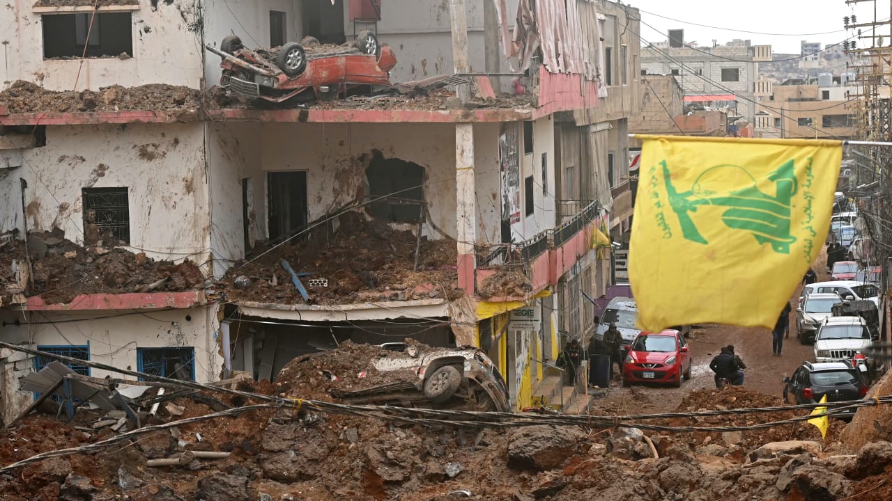 This photograph taken during a media tour organized by the Hezbollah shows a flag of Hezbollah installed on the balcony of a damaged building at Nabi Sheet town after an Israeli military operation in the Bekaa Valley of Lebanon, on March 7, 2026. 