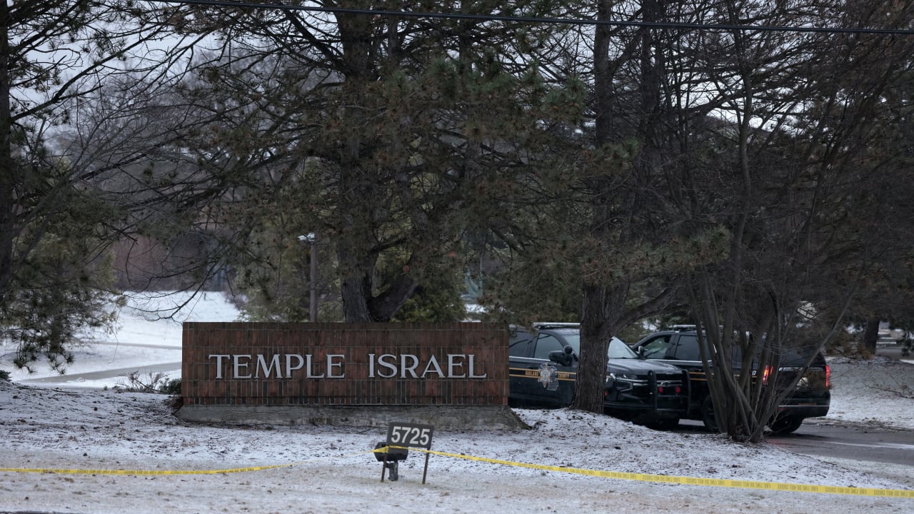 Law enforcement vehicles are seen parked outside Temple Israel guarding the scene in West Bloomfield, Michigan, on March 13, 2026, after an person identified as Ayman Ghazali drove a vehicle into the building.