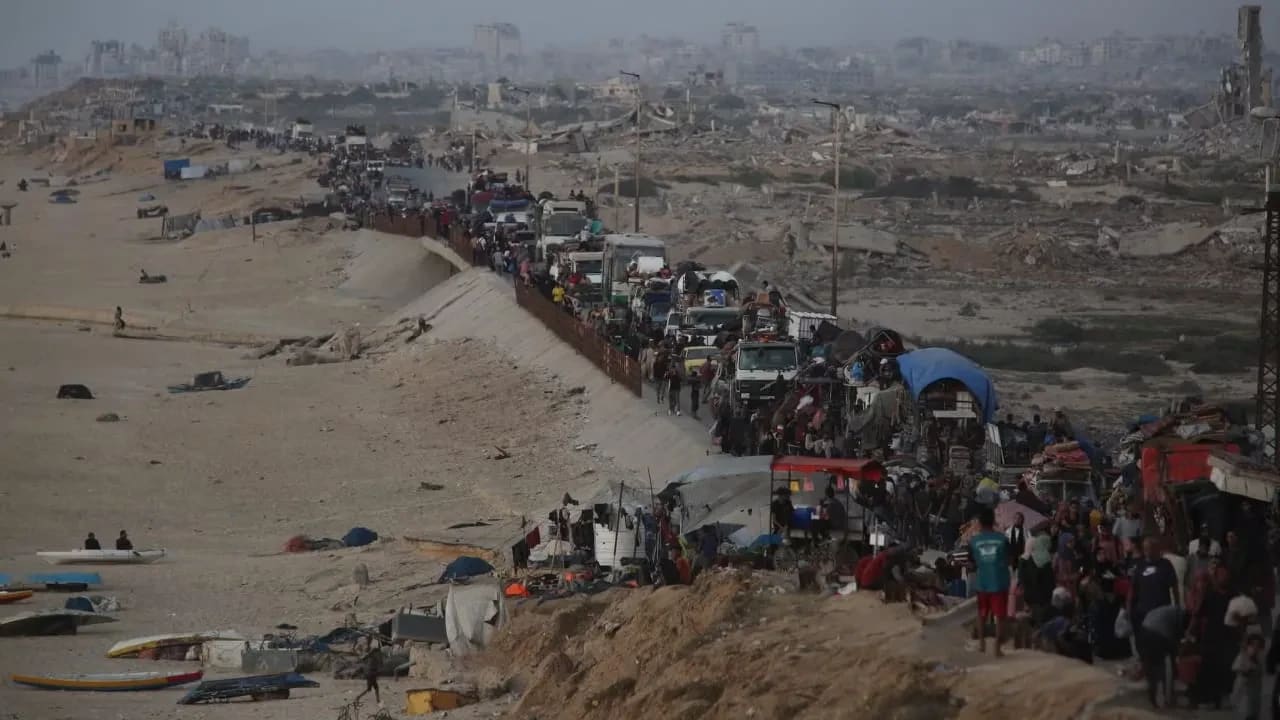 Los palestinos huyen con sus pertenencias cargadas en vehículos y carretillas, mientras otros caminan por la calle Rashid hacia el sur de Gaza, tras la intensificación de los ataques aéreos israelíes y las órdenes de evacuación en las zonas septentrionales del enclave de la ciudad de Gaza