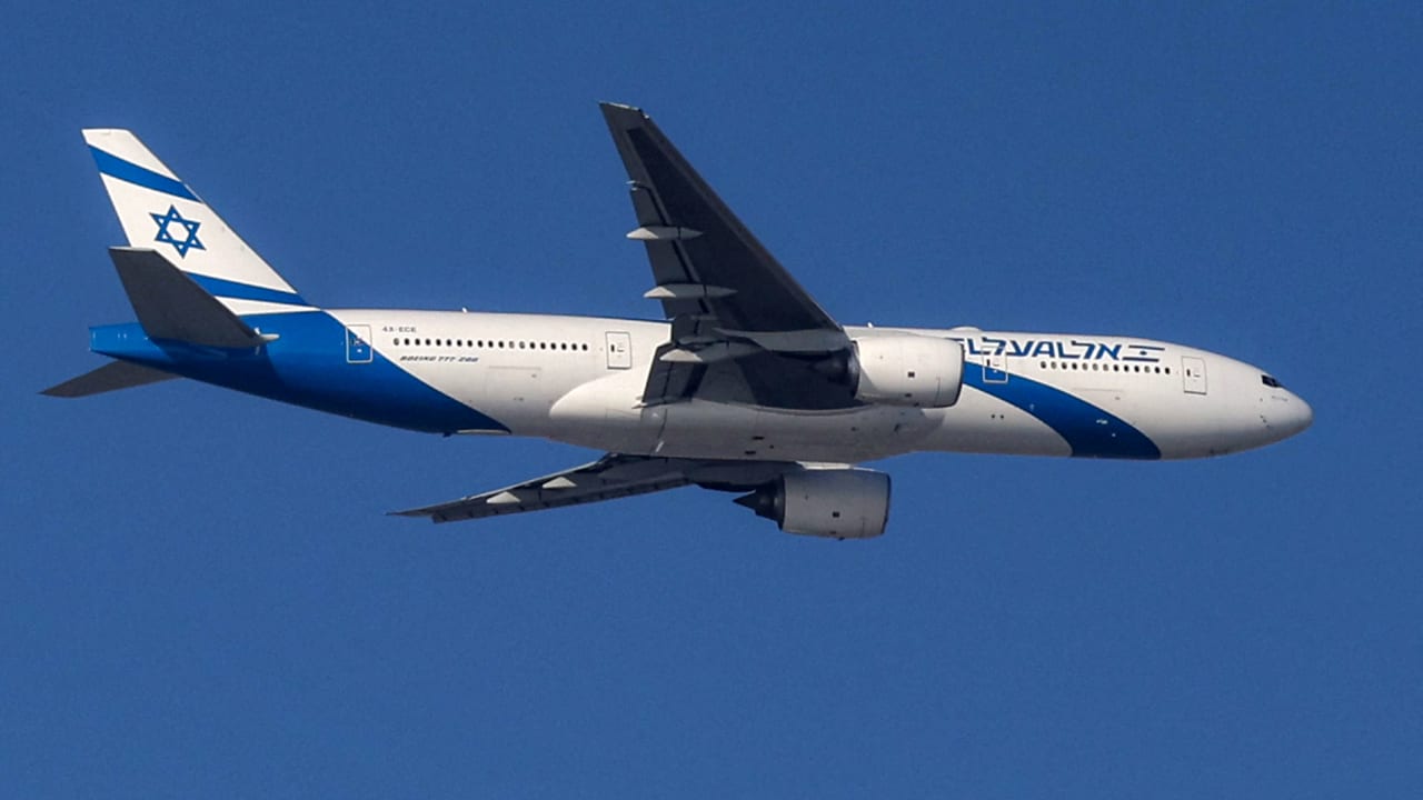 An Israeli El Al Boeing 777 aircraft flies over Tel Aviv during its landing approach to Ben Gurion Airport on March 16, 2026.