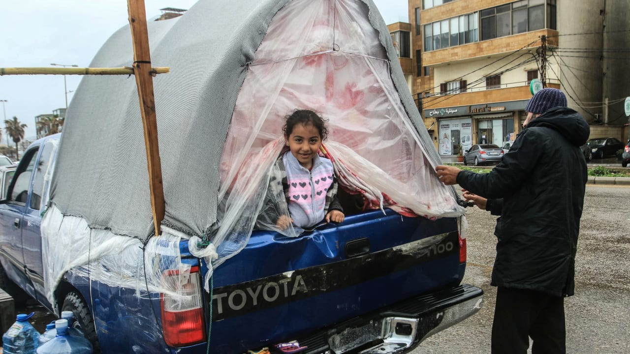 A displaced girl sits in the back of a pick-up truck in Lebanon’s southern city of Sidon on March 15. Lebanon is working to form a delegation to negotiate with Israel in a bid to stop the war with Hezbollah. 