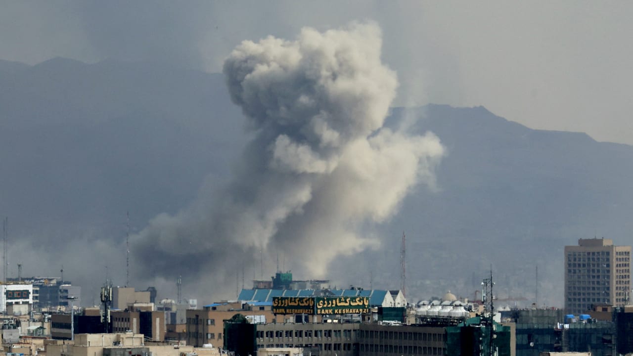 A plume of smoke acends after a military strike on the capital Tehran on March 2, 2026.
