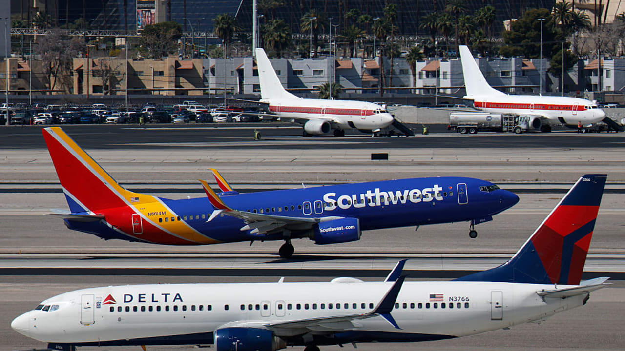 A SOUTHWEST Airlines Boeing 737 airplane departs from Harry Reid International Airport as a Delta Airlines aircraft taxis on March 11, 2026 in Las Vegas, Nevada. 