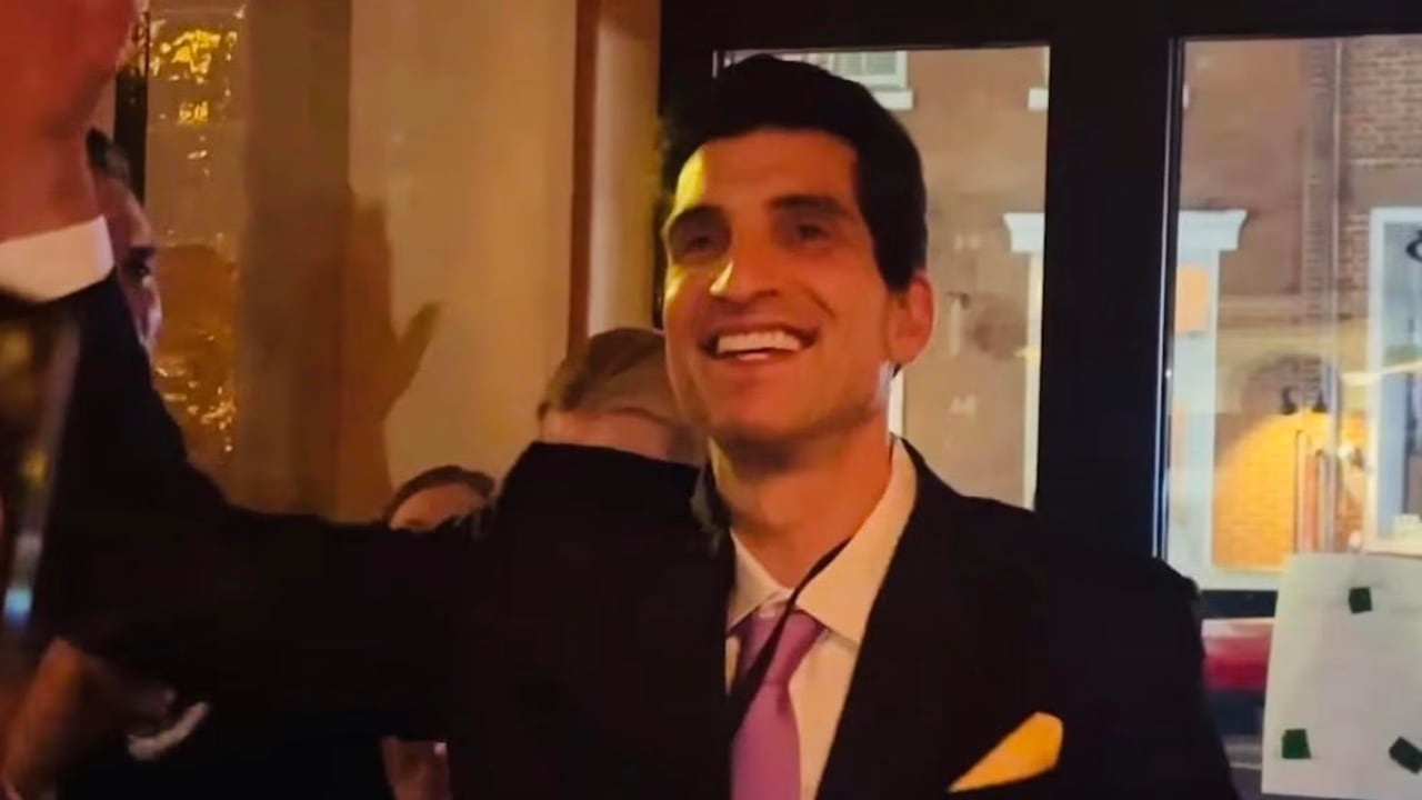 Andrew Ginsburg celebrates after winning a JFK Jr. look-alike competition in the West Village.