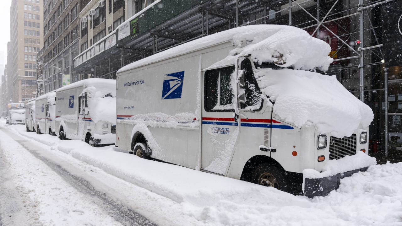 A view of USPS trucks after a day of heavy snowfall on February 23, 2026 in New York City.