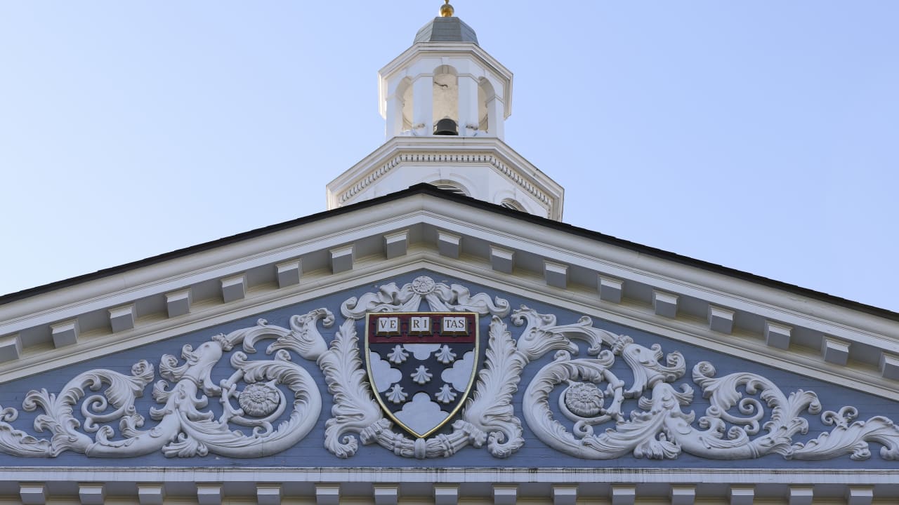 The Harvard University Coat of arms (Ve Ri Tas) is displayed on the front of the Harvard Business School building on October 25, 2025 in Boston, Massachusetts.