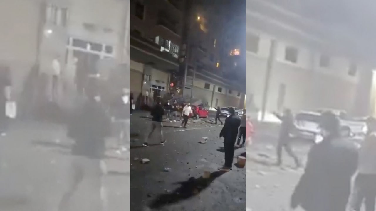People stand amidst debris following an attack on a building in Erbil, Iraq, in this screengrab obtained from a social media video released March 25, 2026.