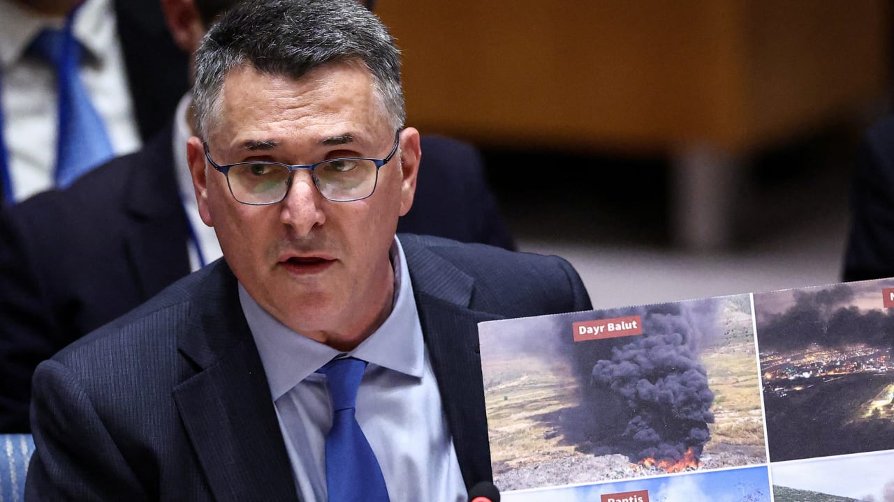 Israeli Foreign Minister Gideon Saar shows photos as he speaks during a United Nations Security Council meeting on the Middle East at UN headquarters in New York on February 18, 2026.