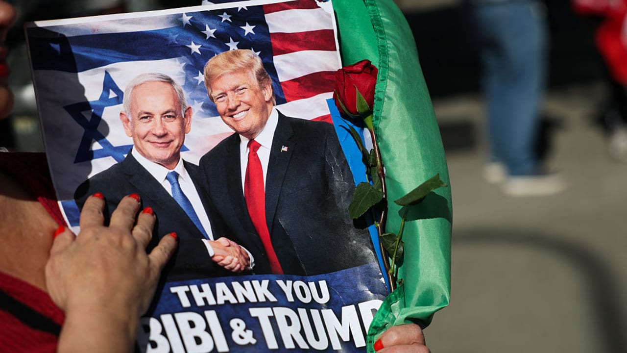 ‘WHATEVER TRUMP’S plans, Israel can emerge from this war with a great diplomatic prize.’ Here, a person holds a sign supporting Prime Minister Benjamin Netanyahu and US President Donald Trump during a gathering of Iranian community members showing support for Israel and the US, earlier this month.