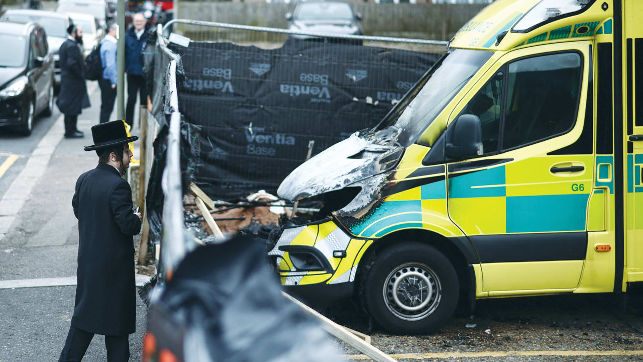 THE RISE of lone-actor terrorism in place of state-sponsored terror? Here, a member of the Jewish community views the scene of an antisemitic arson attack through a makeshift fence in London, on Tuesday, a day after volunteer ambulances run by a Jewish organization were set on fire.