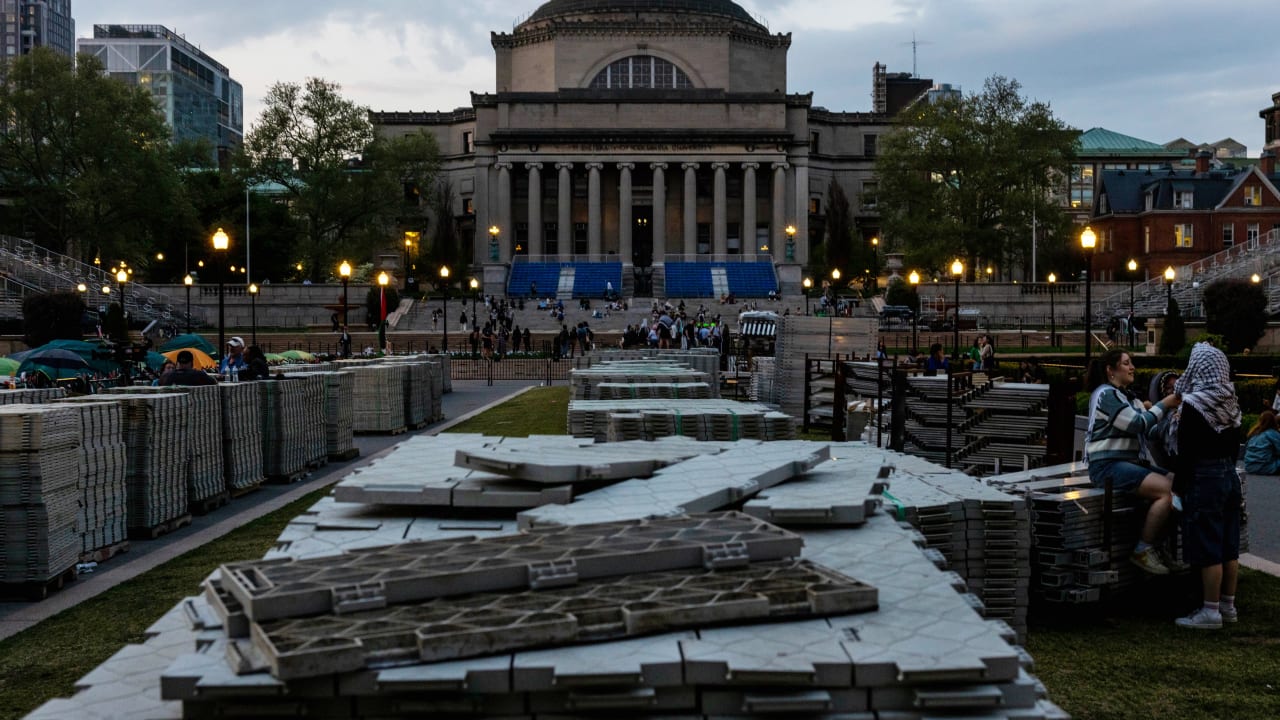One demonstrator fixes another head scarf outside the pro-Palestine encampment on the Columbia University campus on April 29, 2024 in New York City.