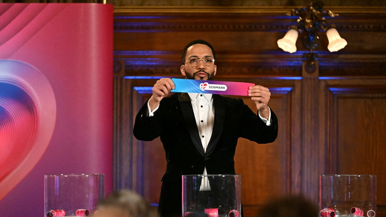 Moderator Austrian singer Cesar Sampson holds a draw for Denmark during the draw session for the two semi-final events of the Eurovision Song Contest 2026 on stage at the Vienna's city hall in Vienna, Austria, on January 12, 2026.
