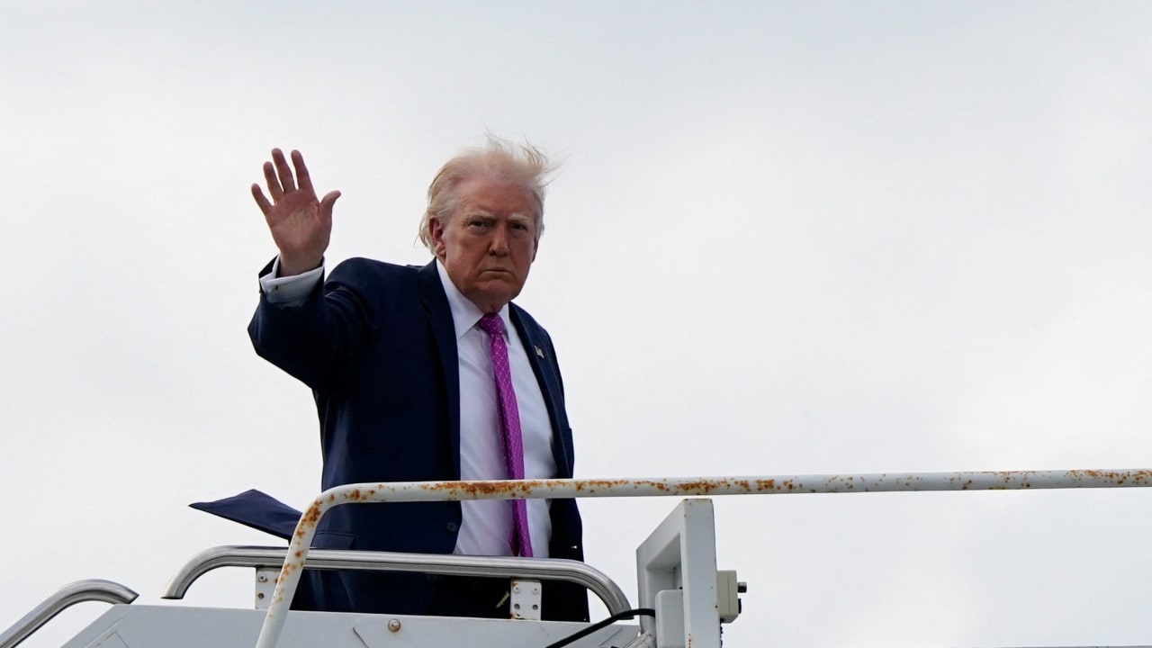 US President Donald Trump waves as he boards Air Force One at Palm Beach International Airport in West Palm Beach, Florida, US, March 29, 2026.