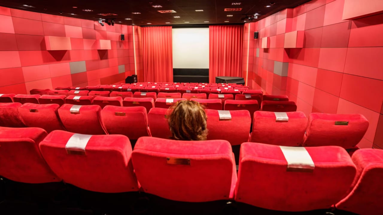 A woman sits alone in a Frankfurt, Germany, cinema in November 2021.