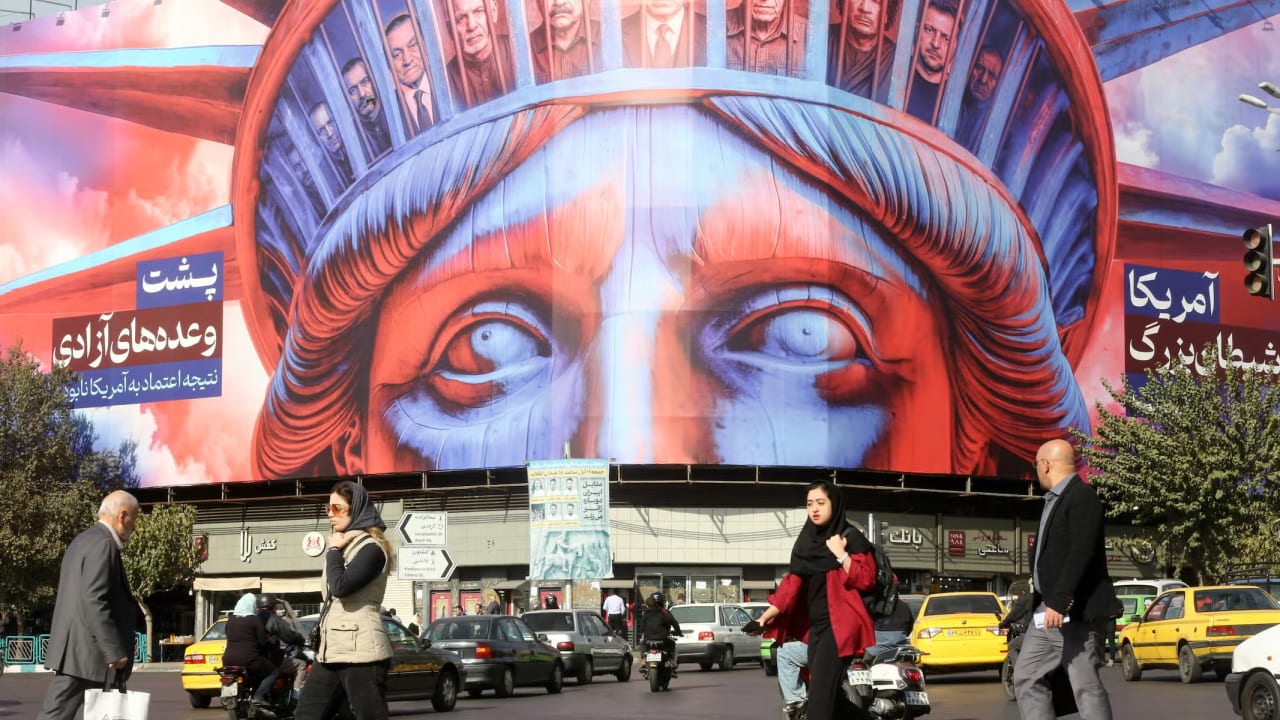 A poster is hung in Tehran's Revolution Square featuring an image of the Statue of Liberty, and photographs of several heads of state to mark the 46th anniversary of the U.S. Embassy takeover and hostage crisis in Tehran, Iran on November 5, 2025.