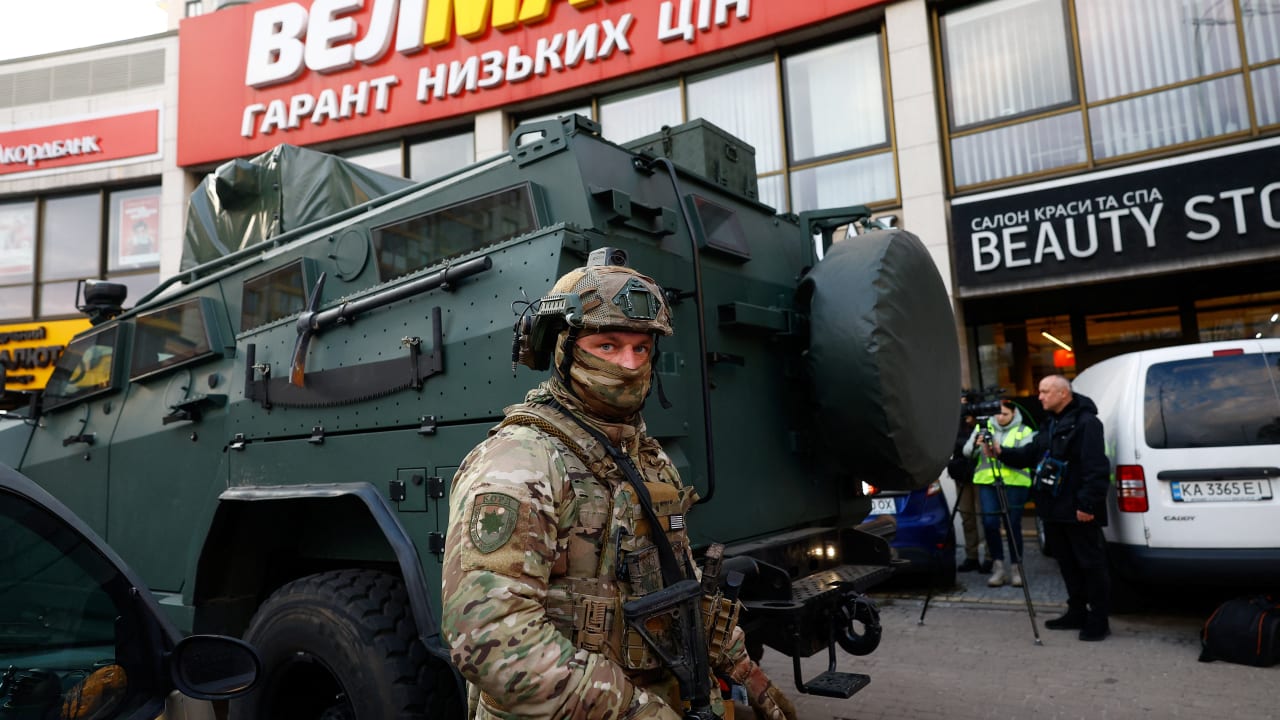 A Rapid Operational Response Unit member stands by an armoured vehicle outisde a supermarket, where Ukrainian police killed a man who opened fire in a city district and barricaded himself into the supermarket on Saturday, Ukrainian Interior Minister Ihor Klymenko said, in Kyiv, April 18, 2026.