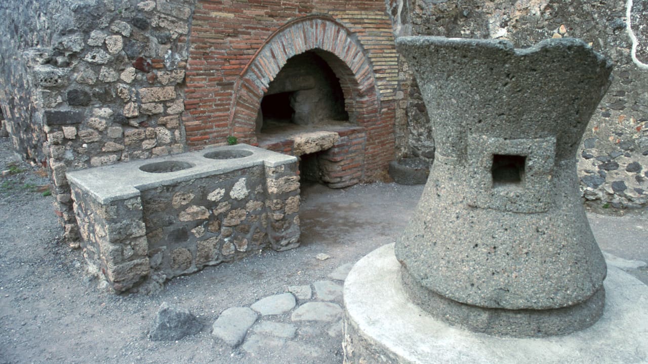 File photo: First century bakery in the Roman town of Pompeii, showing corn-mill, oven, and food counter, January 1, 1900.