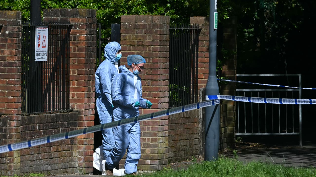 Police forensic officers work inside a cordon set up near to Kenton United Synagogue in Harrow, north-west London on April 19, 2026, the scene of an arson attack overnight.