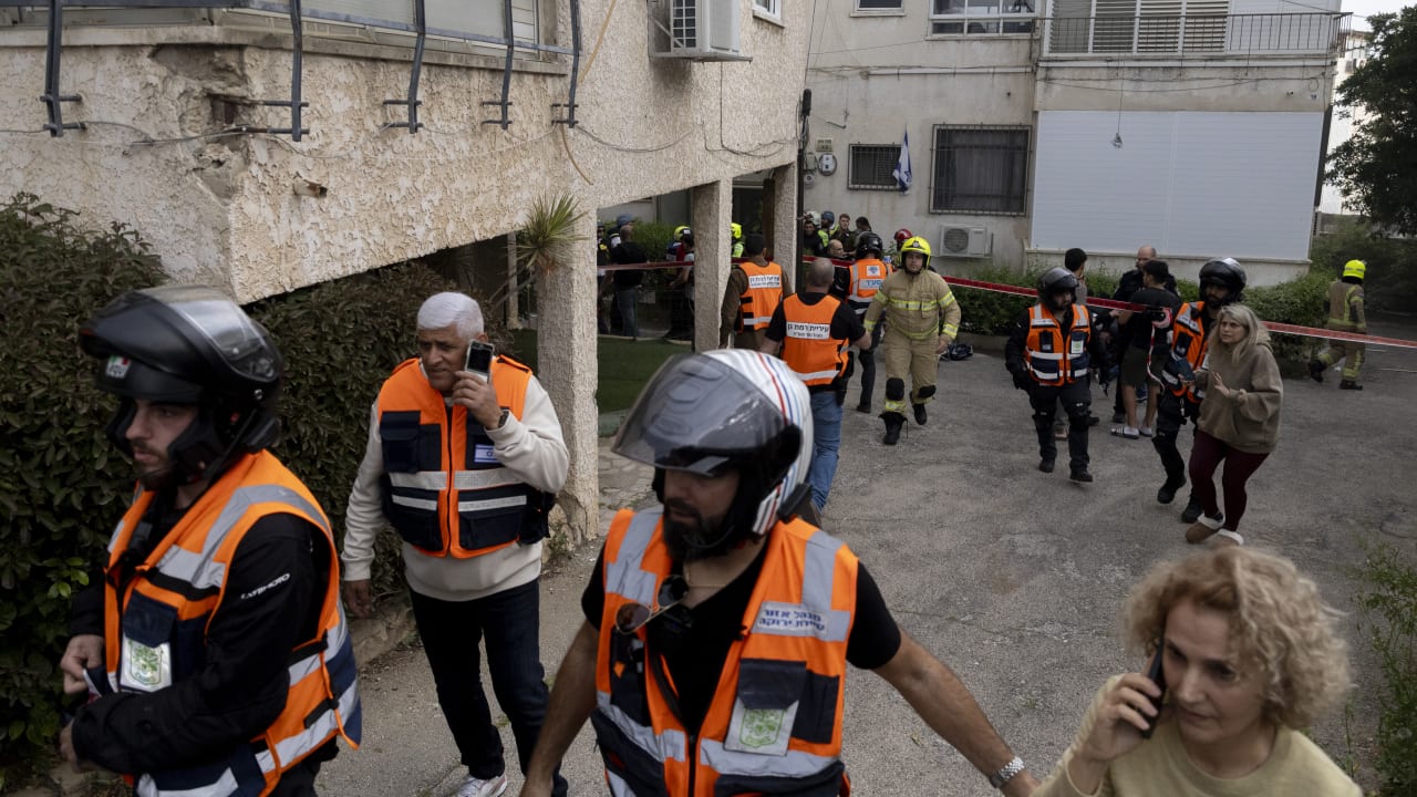 An Israeli emergency responder inspects the impact of an Iranian missile strike at an apartment in Ramat Gan, March. 