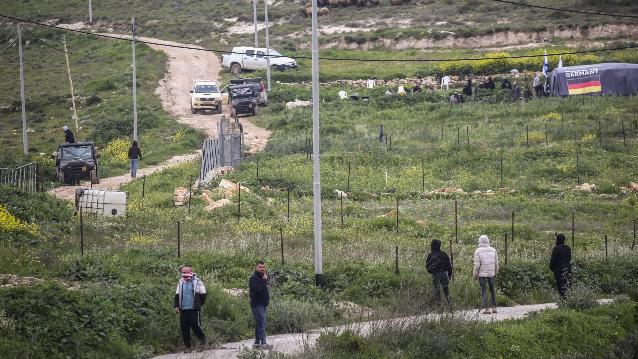Palestinians throw stones at Jewish settlers as they establish a pastoral outpost at the site where Jewish settler Yehuda Sherman was murdered, near the village of Beit Mirin north of Nablus in the West Bank.