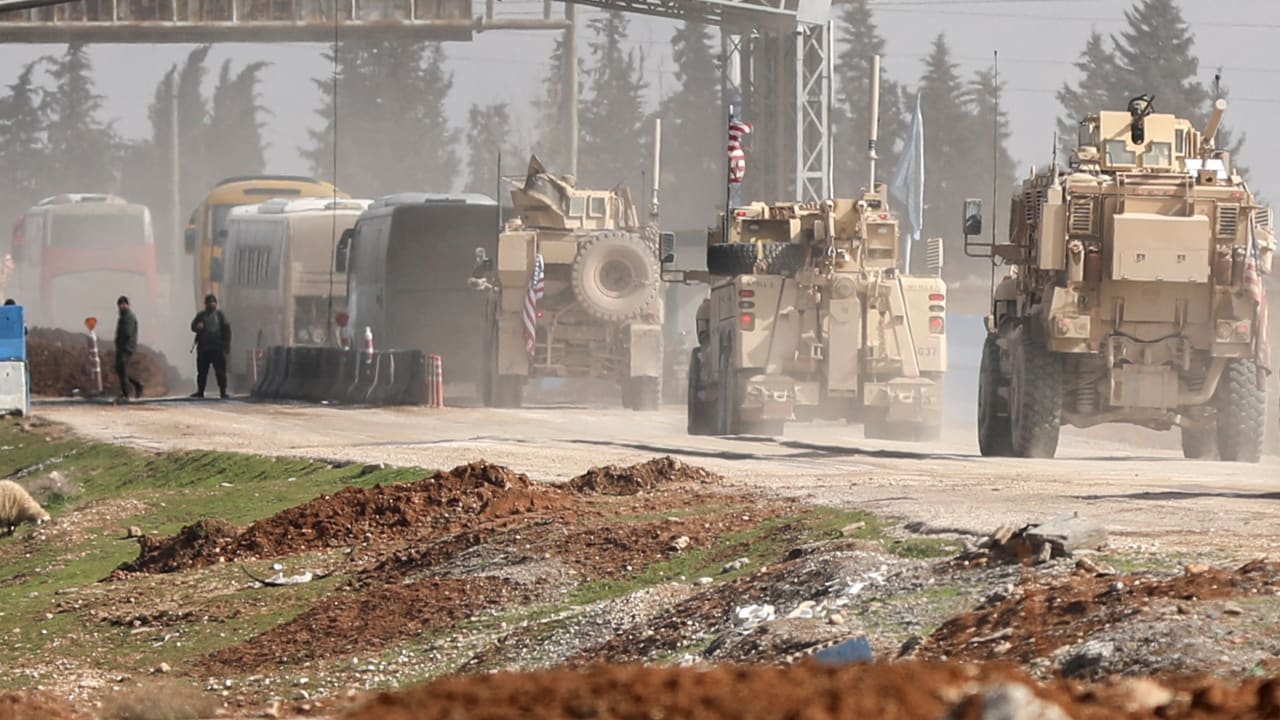 U.S. military vehicles escort buses transporting Islamic State detainees from Syria to Iraq, according to a security source from the Syrian Democratic Forces, in Qamishli, Syria, February 8, 2026.