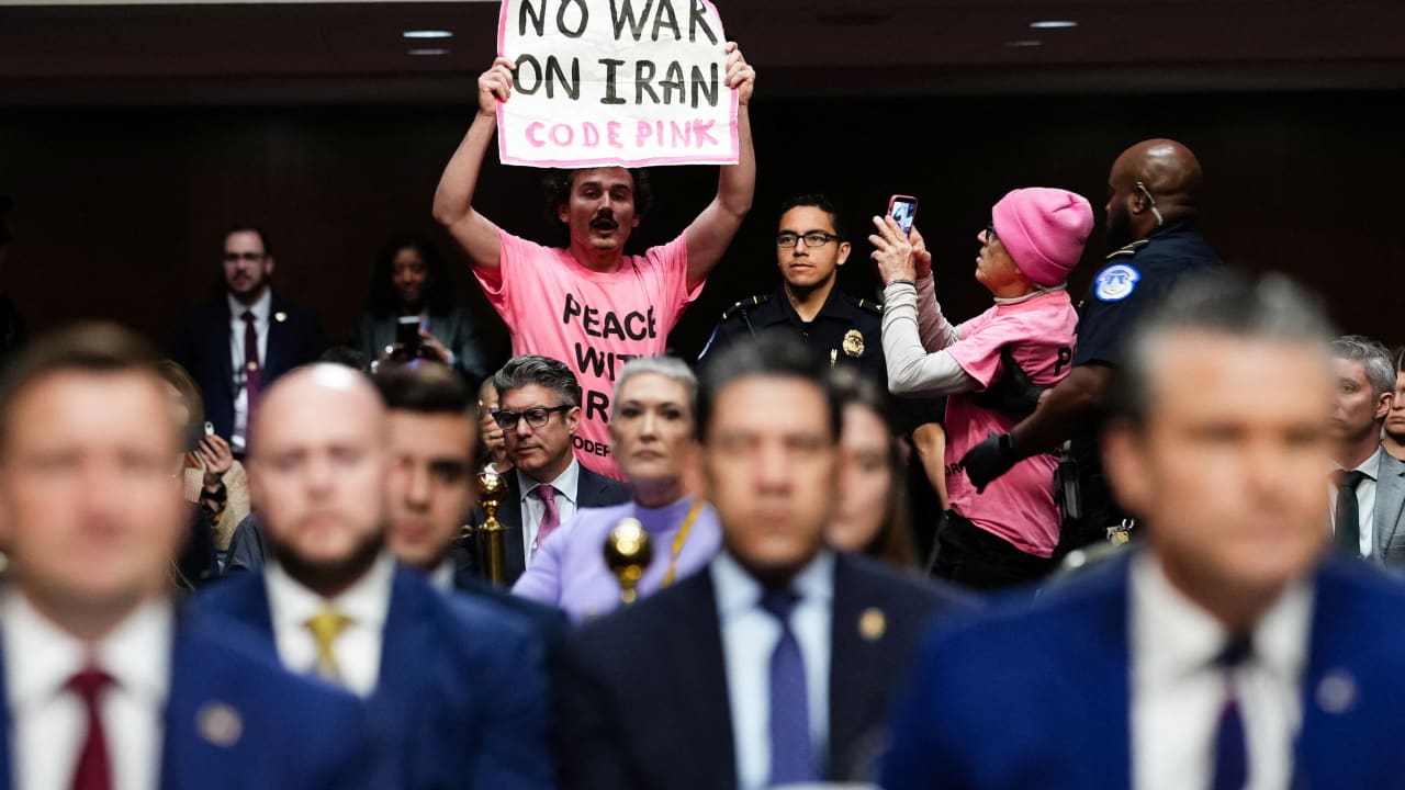 A protester holds a banner opposing the war with Iran during US Defense Secretary Pete Hegseth's opening remarks at a Senate Armed Services Committee hearing on US President Donald Trump's FY2027 budget request for the Department of Defence on Capitol Hill in Washington, DC, US, April 30, 20