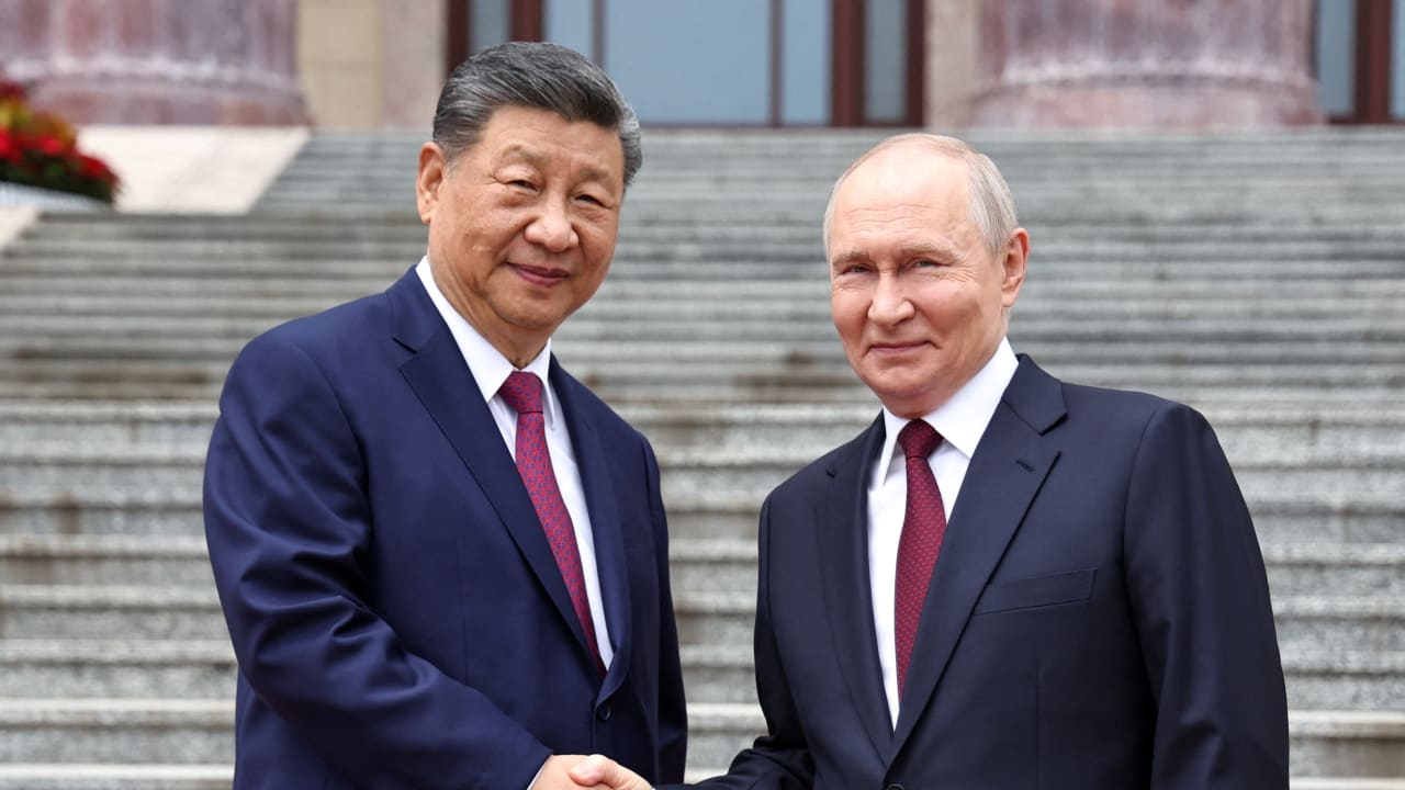 Russian President Vladimir Putin shakes hands with Chinese President Xi Jinping during a welcoming ceremony at the Great Hall of the People in Beijing, China May 20, 2026. 