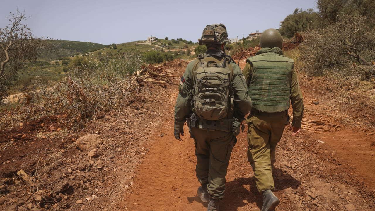 Israeli soldiers walk through a village in southern Lebanon during an Israeli military operation, May 17, 2026.
