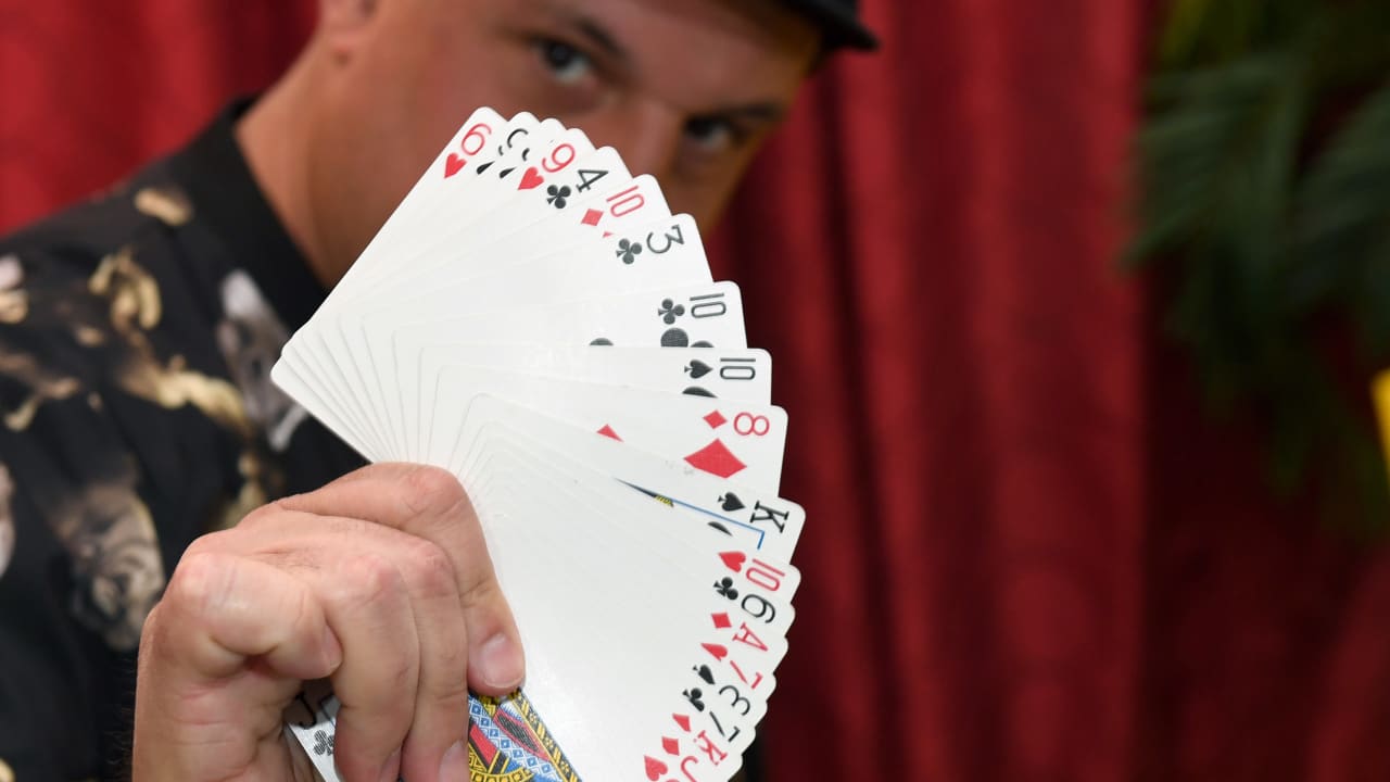 Creative director/magician Douglas "Lefty" Leferovich fans out a deck of cards before teaching magic tricks on Facebook Live with magician/comedian Murray SawChuck from SawChuck's home to entertain people under stay-at-home orders to fight the spread of the coronavirus on April 25, 2020 in Las Vegas