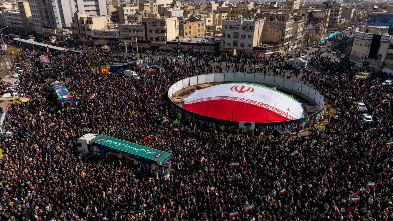 Large crowds gather during a joint funeral held for Ali Larijani, Secretary of Iran's Supreme National Security Council, Basij commander Major General Gholam Soleimani, and 84 sailors from the Iranian Navy frigate IRIS Dena, on March 18, 2026 in Tehran, Iran.