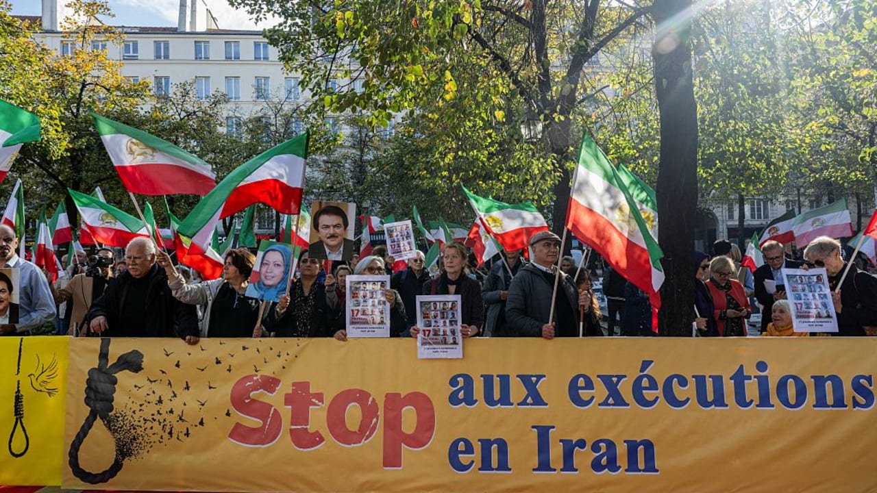 Protestors wave flags of the National Council of Resistance of Iran (NCRI) during a demonstration by Franco-Iranian associations, including the Committee to Support Human Rights in Iran (CSDHI) against the capital punishment in Iran, a day after the World Day Against the Death Penalty.