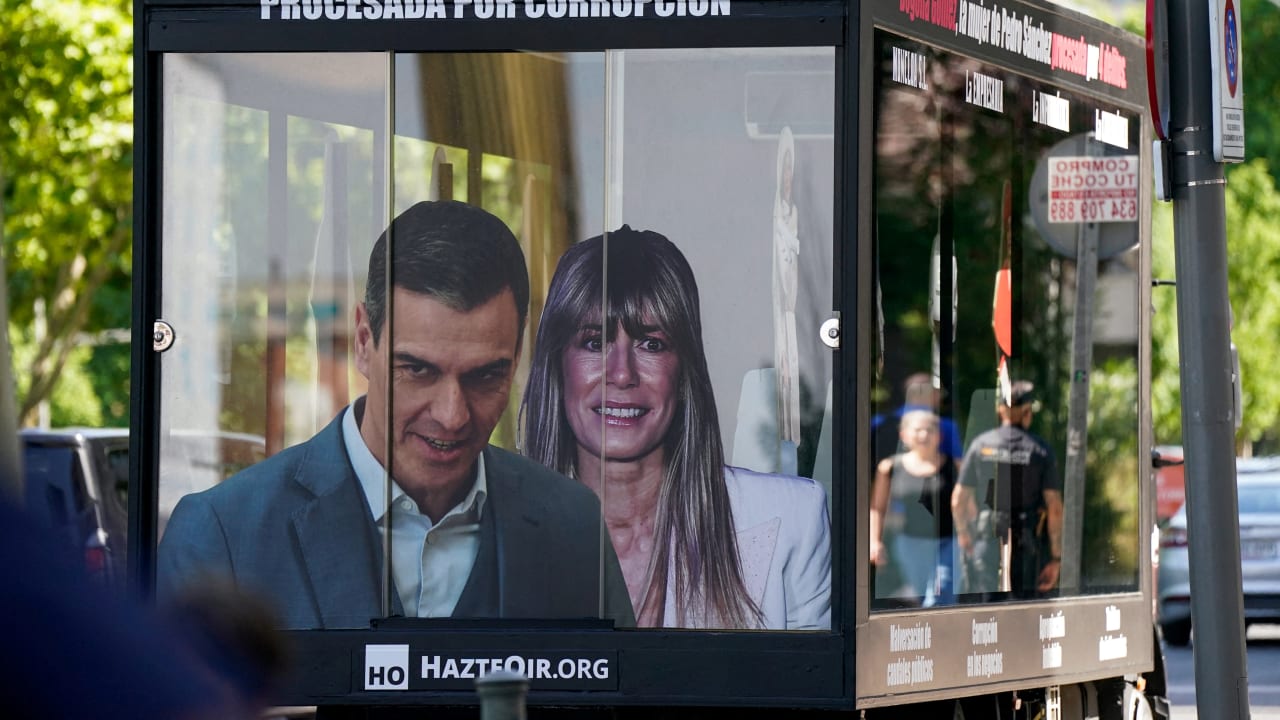 A truck displaying images of Spanish Prime Minister Pedro Sanchez and his wife Begona Gomez drives outside the court as a way of protest on the day Gomez appears in court to testify as part of influence-peddling investigation, in Madrid, Spain, June 15, 2026.