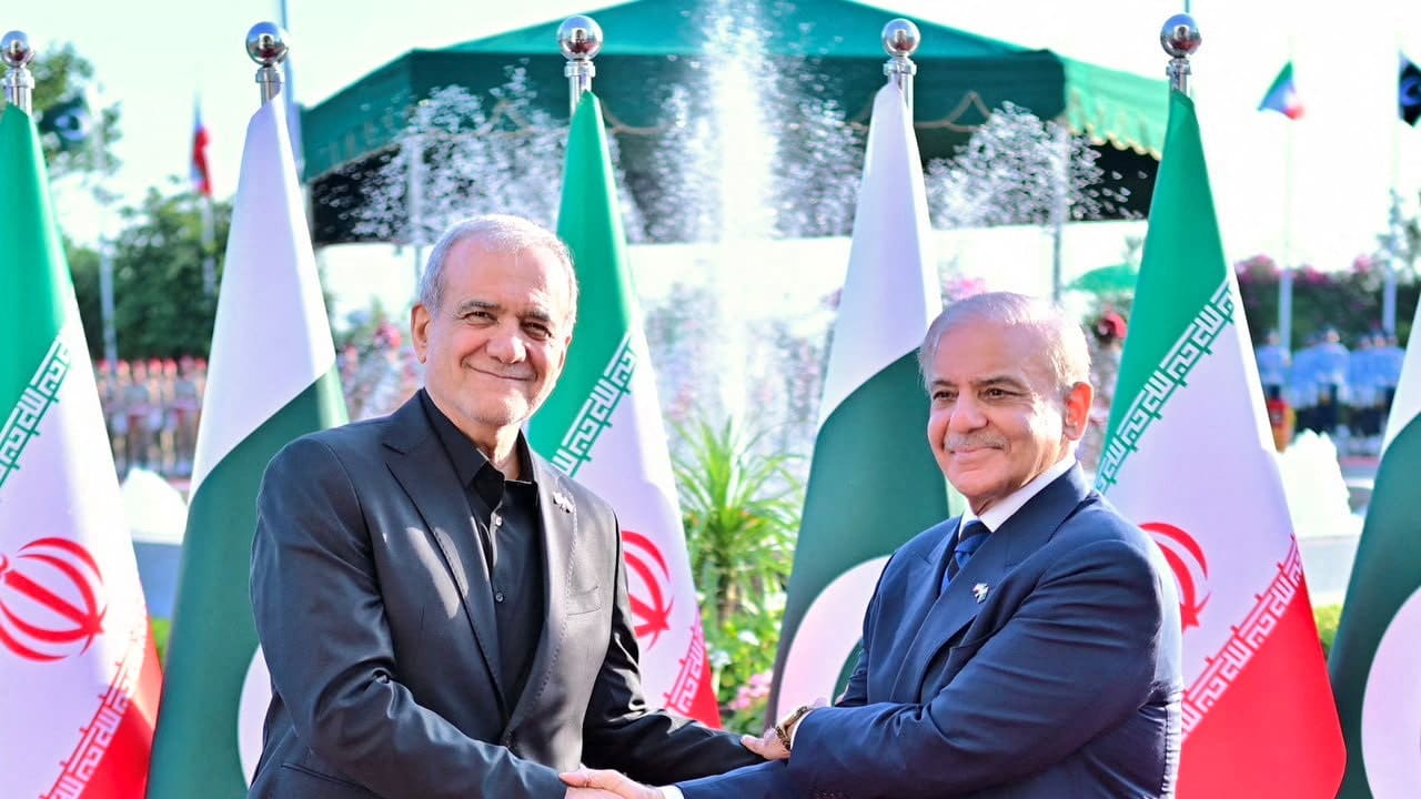 Pakistan's Prime Minister Shehbaz Sharif receives Iranian President Masoud Pezeshkian, upon his arrival at the Prime Minister's House in Islamabad, Pakistan, June 23, 2026.