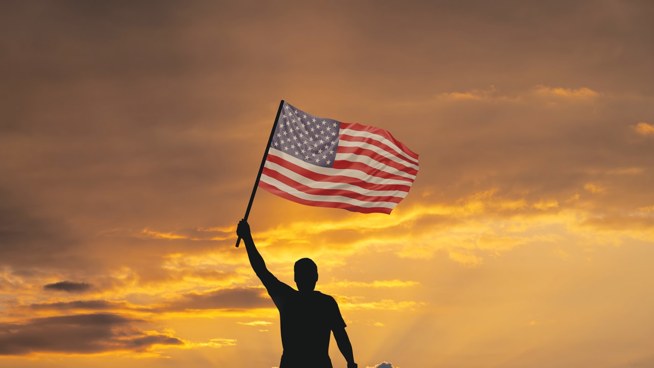 Man holding an American flag.