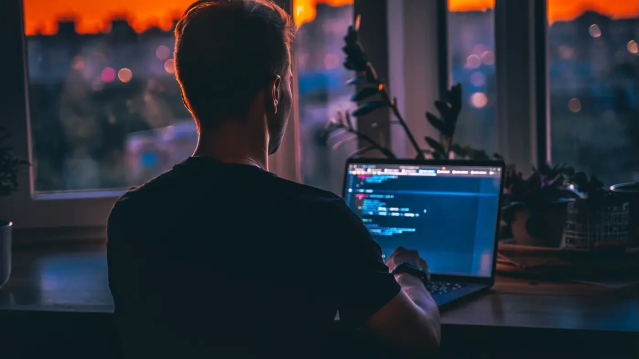 A man writing a code on his conputer