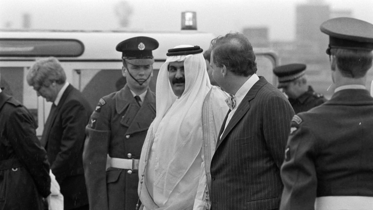 FILE PHOTO: Qatar's heir apparent Sheikh Hamad bin Khalifa Al Thani (L) is greeted by Lord Hesketh, representing Queen Elizabeth II, on his arrival for an official visit at Heathrow Airport in London, Britain, March 20, 1988.