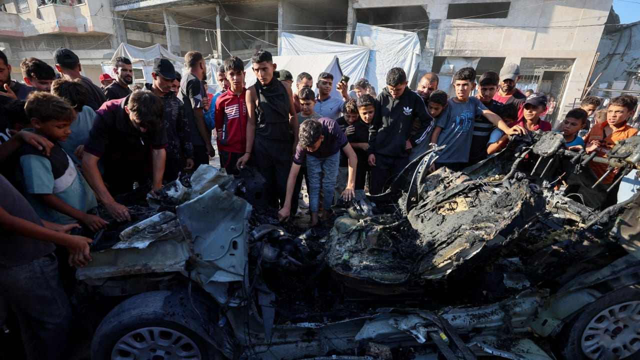 Palestinians inspect the site of an Israeli strike on a vehicle in Gaza City, July 8, 2026.