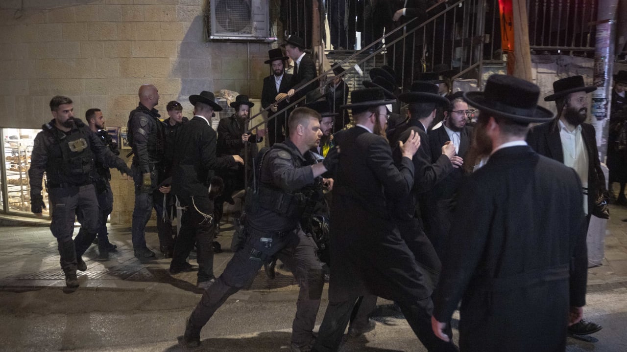 Ultra-Orthodox Jewish men clash with police during a protest against construction work on the Jerusalem Light Rail in the Bar-Ilan area of Jerusalem, June 8, 2026. 