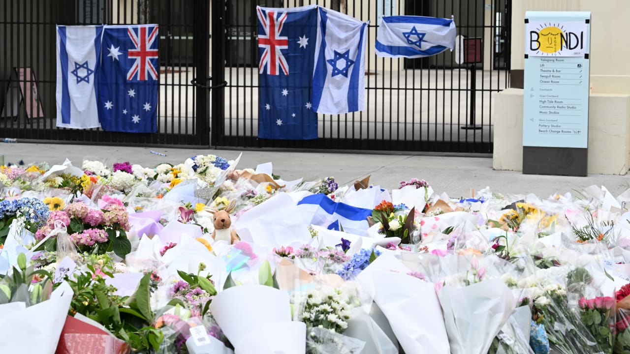 Local residents, both Jewish and non-jewish visit the inundated flower memorial next to Bondi Pavilion to pay their respects at Bondi Beach on December 16, 2025 in Sydney, Australia.