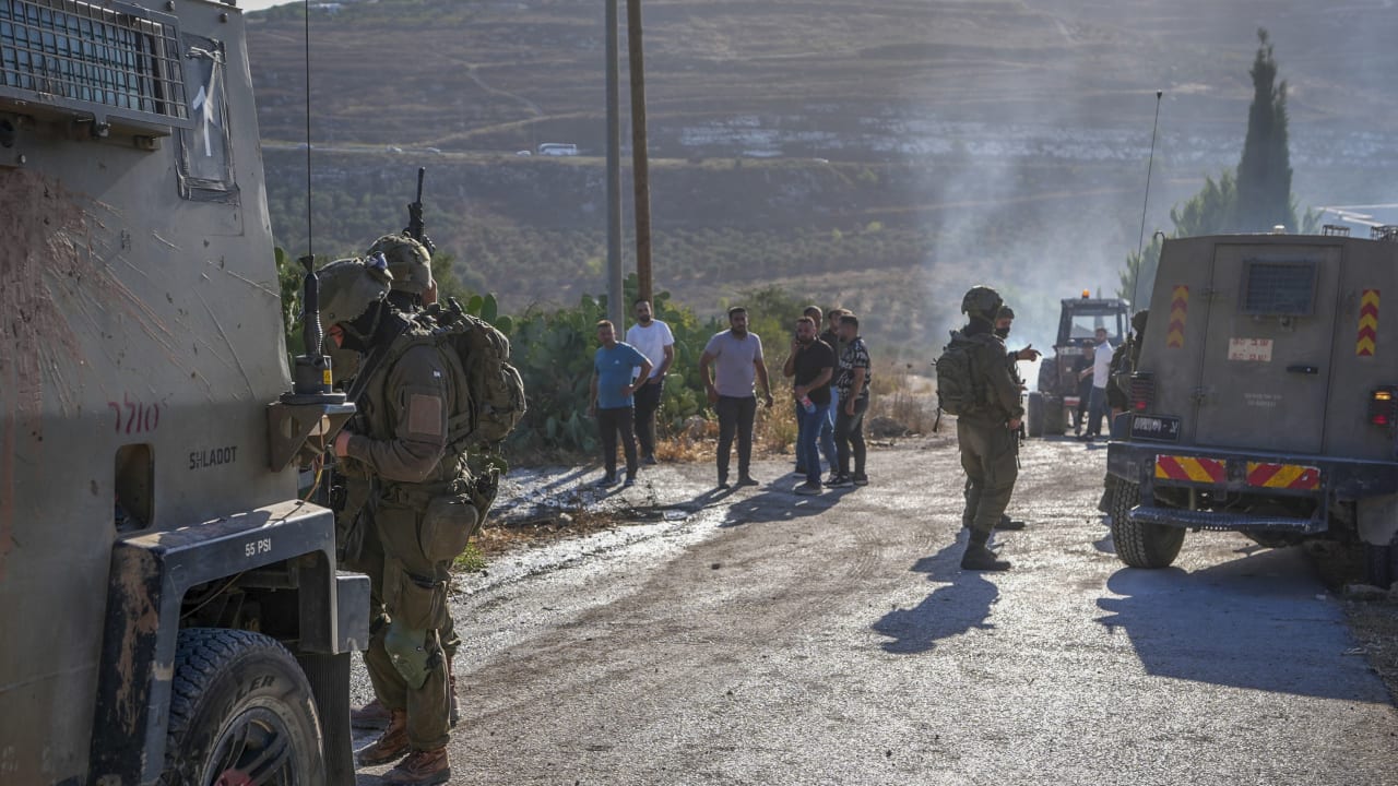 Israeli soldiers inspect the damage following an attack by Israeli settlers in the village of Sarra, near the West Bank city of Nablus, July 24, 2026.